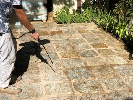 Applying sealant to stone.
